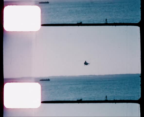 Film footage of an aircraft flying over the water