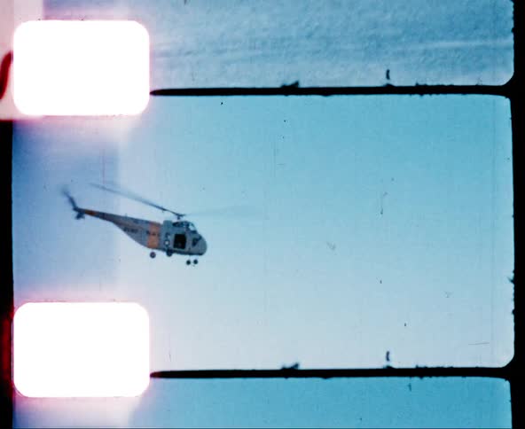 Helicopter flying on the blue sky on vintage film