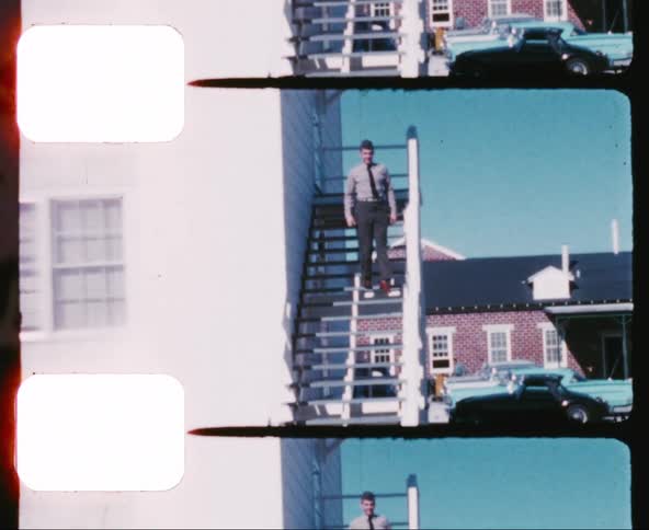 A man with a shirt and tie walking downstairs