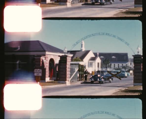Film footage of a guard letting a vehicle in to an area