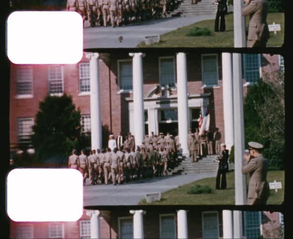 Soldiers in formation march into the entrance of a building