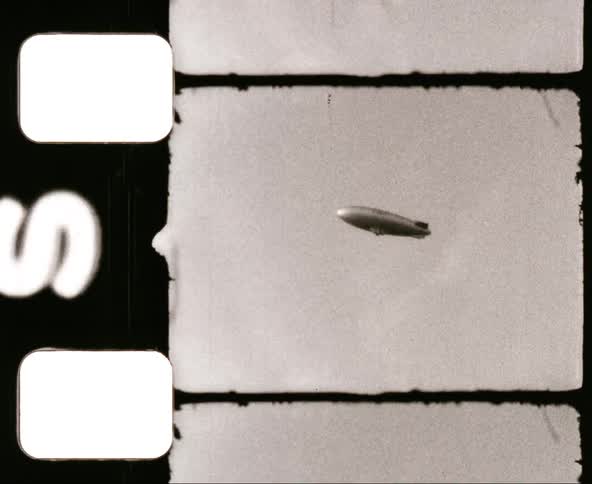 A blimp flies across the sky