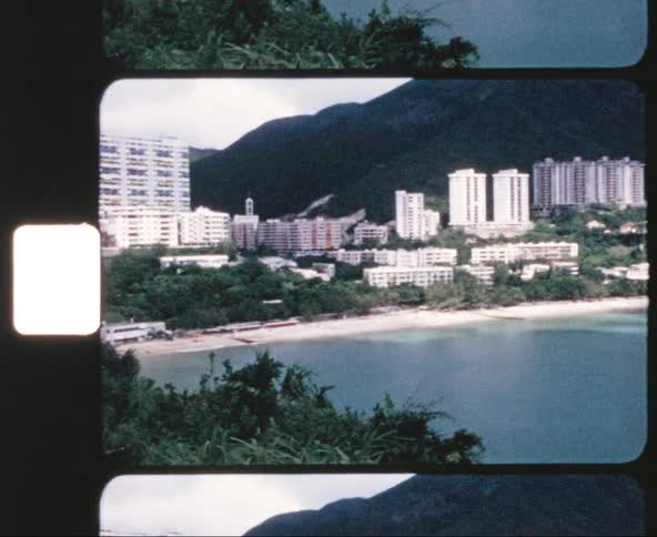 Coastal town and buildings next to the white sand beach