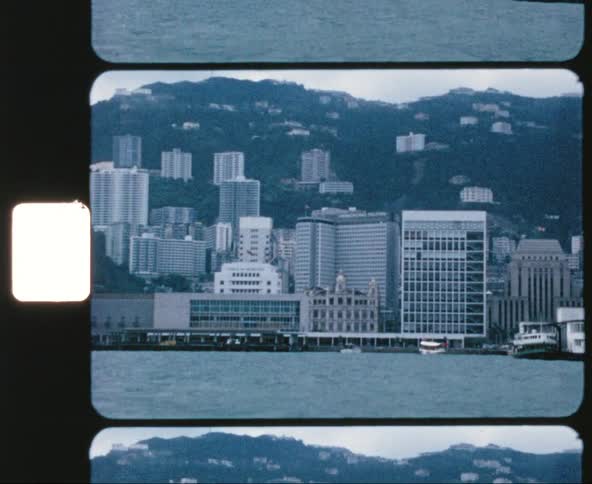 View of the hotel buildings next to the sea from a moving boat