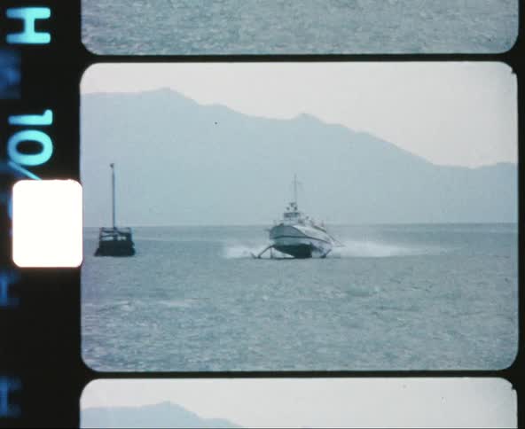 A hovercraft type boat moves across a large body of water