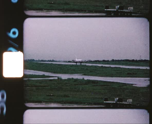 Vintage footage of a plane coming in for a landing at an airport