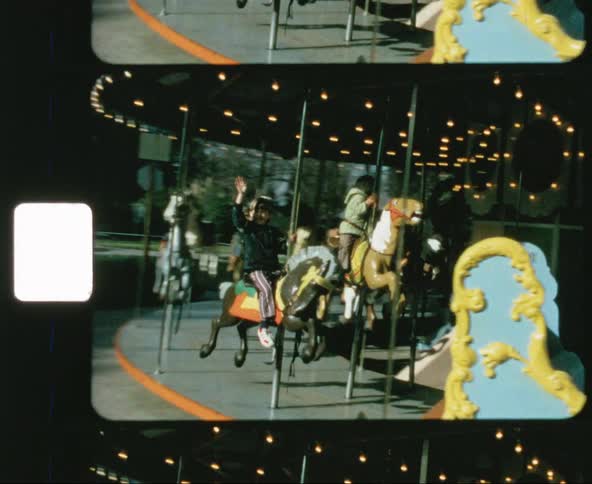 Kids ride a carousel in a park