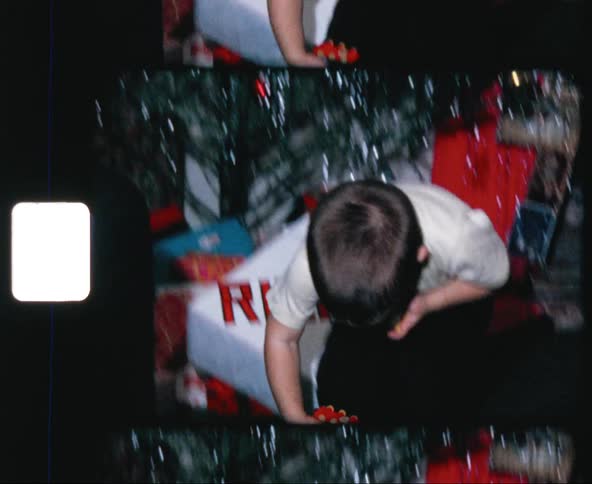 Father and son play with toys under christmas tree
