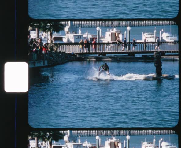 Man riding dolphins performs in front of audience