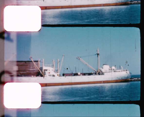 A ship in dock with cargo containers and cranes