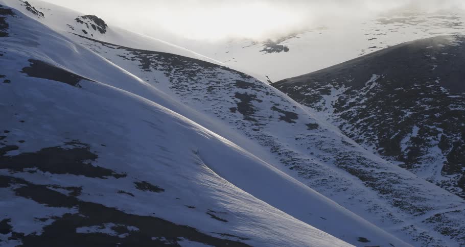 Aerial of snowy mountains in beautiful light