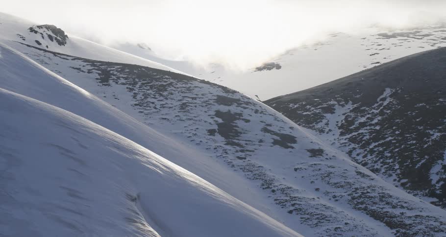 Aerial of a rocky and snowy valley