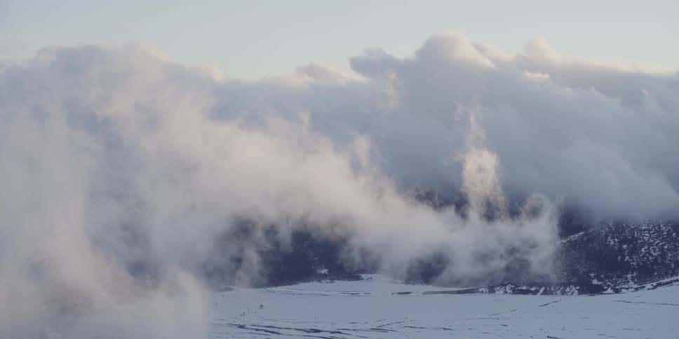 Clouds moving across a mountain
