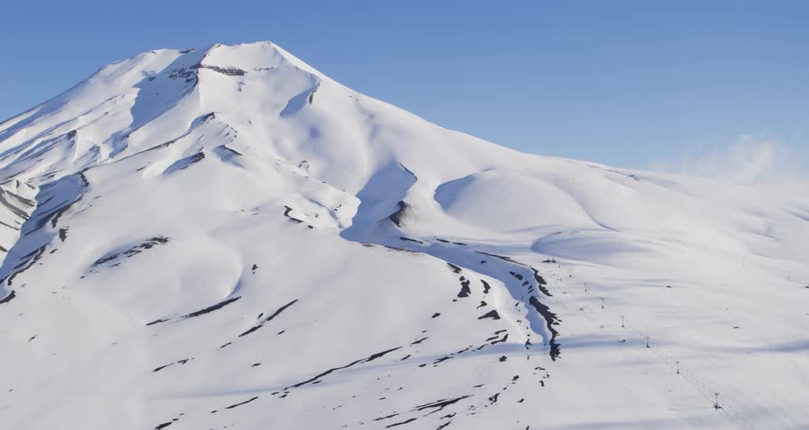 Aerial of a ski lift going up a mountain on a volcano