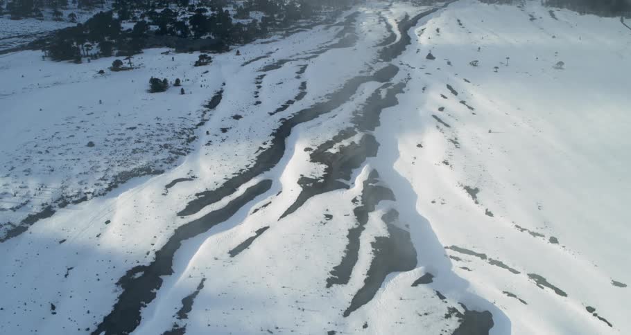 Aerial of fog and clouds over snow covered landscape