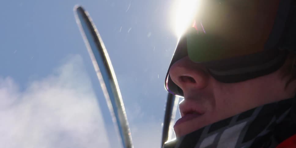 Man wearing ski goggles breathes out vapor in the cold