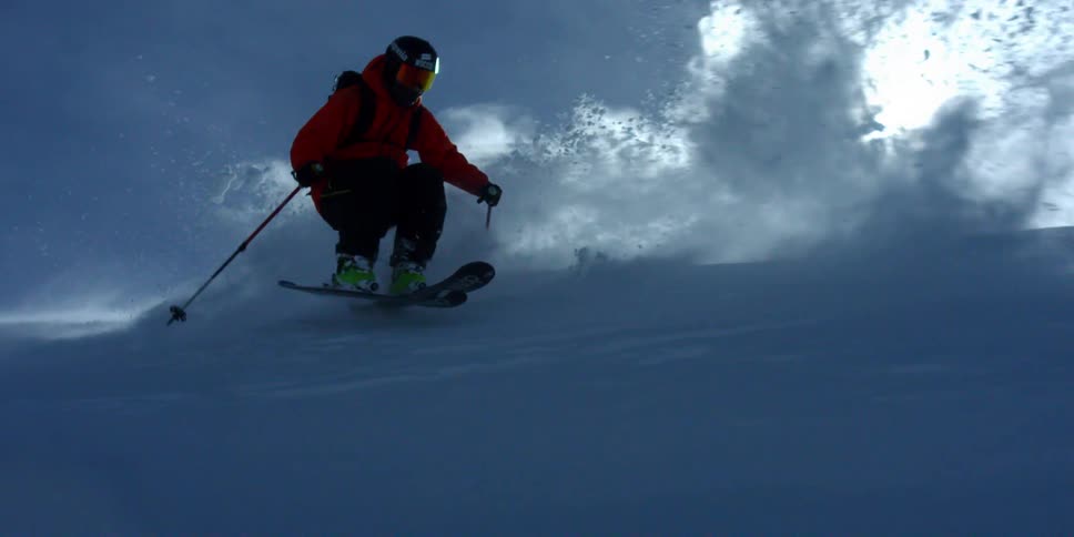 A skier sprays powder through beautiful windblown snow