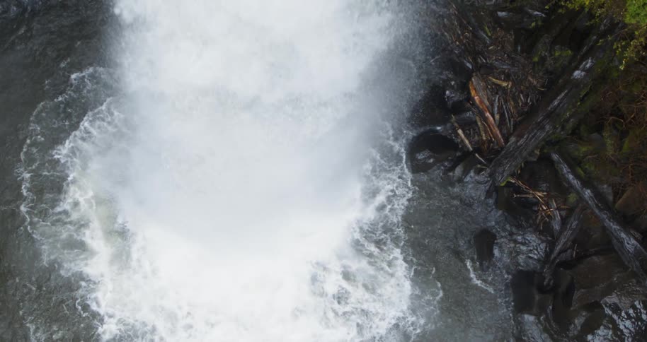 Aerial view of a waterfall crashing in to the river below