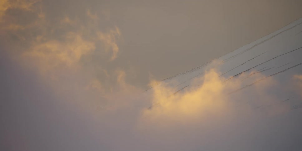 A fiery cloudy sky over mountain slopes at sunset