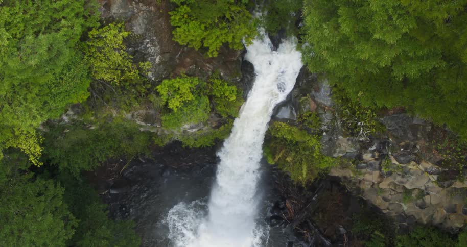 Aerial descending on a beautiful forest jungle waterfall