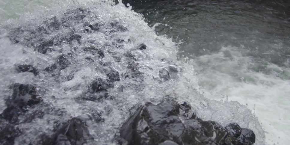 Water falls over an edge of rock