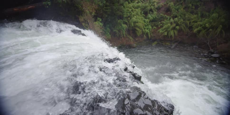 A waterfall crashing in to the river below