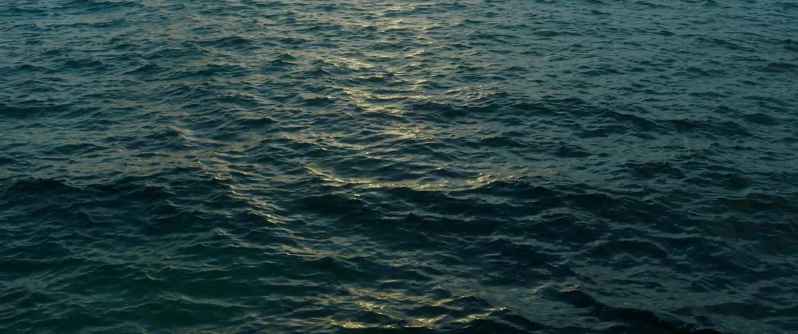 View of choppy sea at dusk