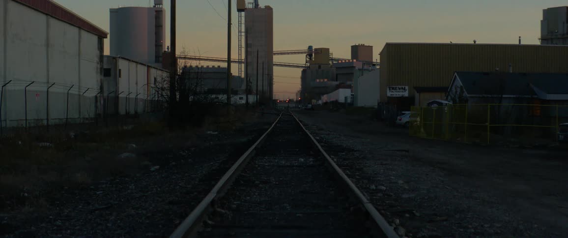 Train tracks fun near factories in a city