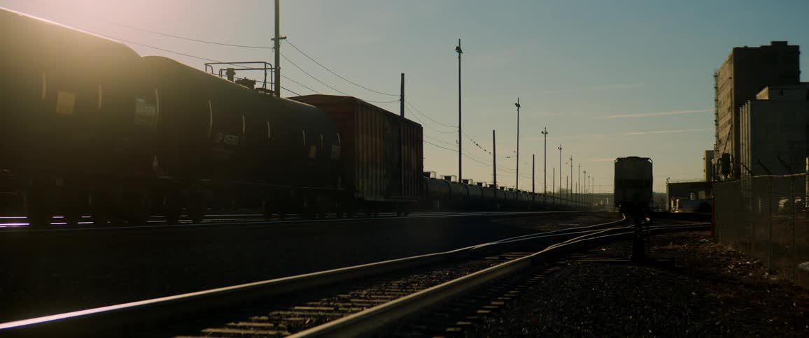 A train sits beside railway tracks