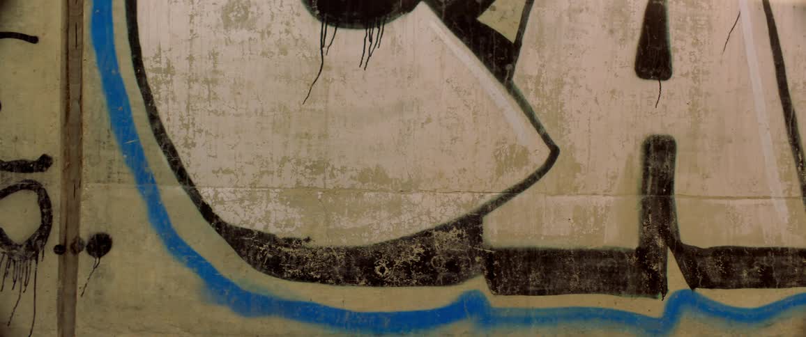 Blue line outlines area of graffiti letters painted in black and white