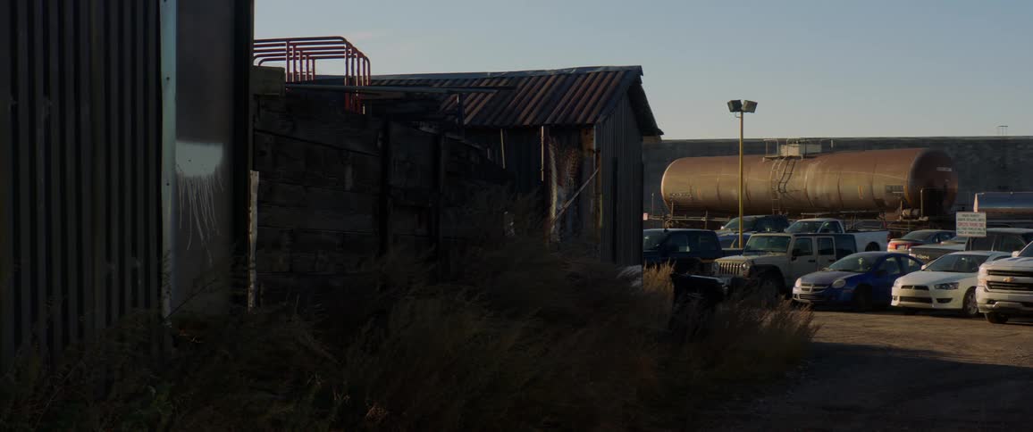 Cars sitting outside a factory