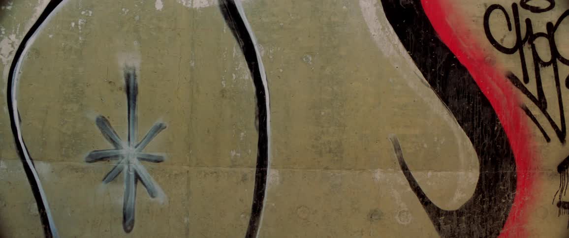 Graffiti spray painted on cement wall
