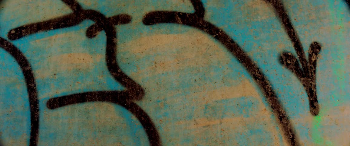 Close up of graffiti on textured concrete wall