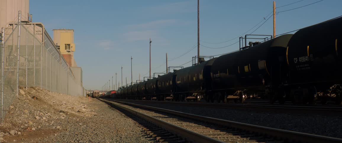 Train tanker cars on track in railyard