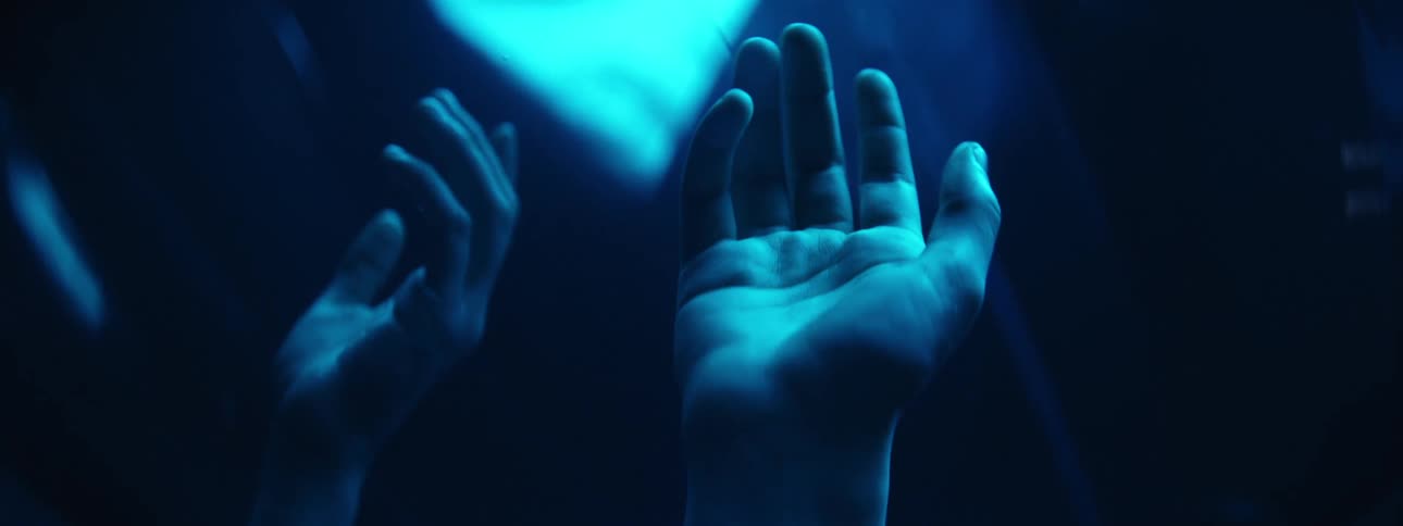 Two hands reach out with their palms facing up