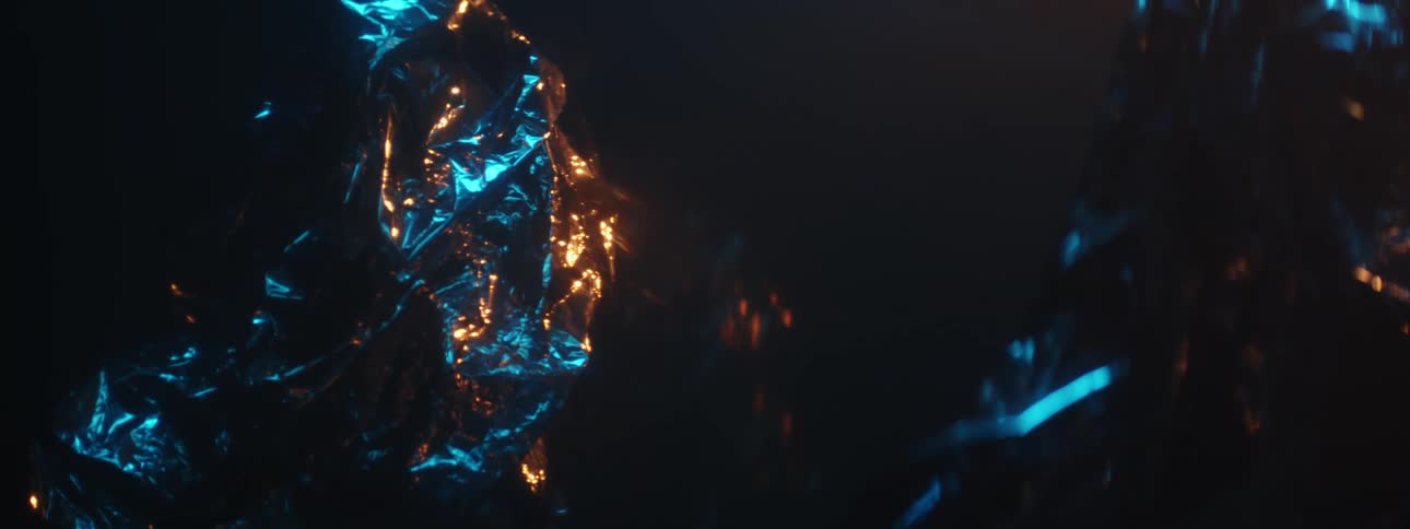 Dark ridged objects light up with orange and blue lights