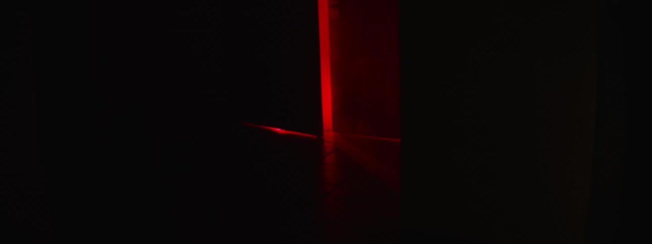Dark red light shining through double doors