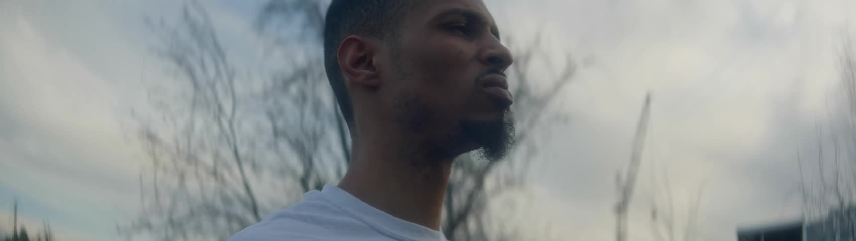 A man walking outside looks around