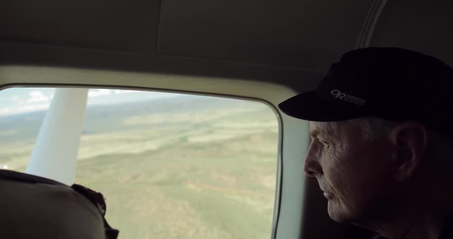 A man looks out of a plane window
