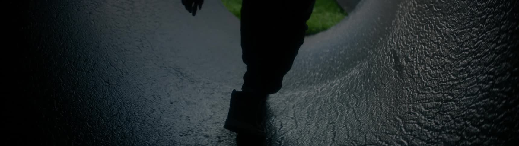 Silhouette of person walking through small tunnel