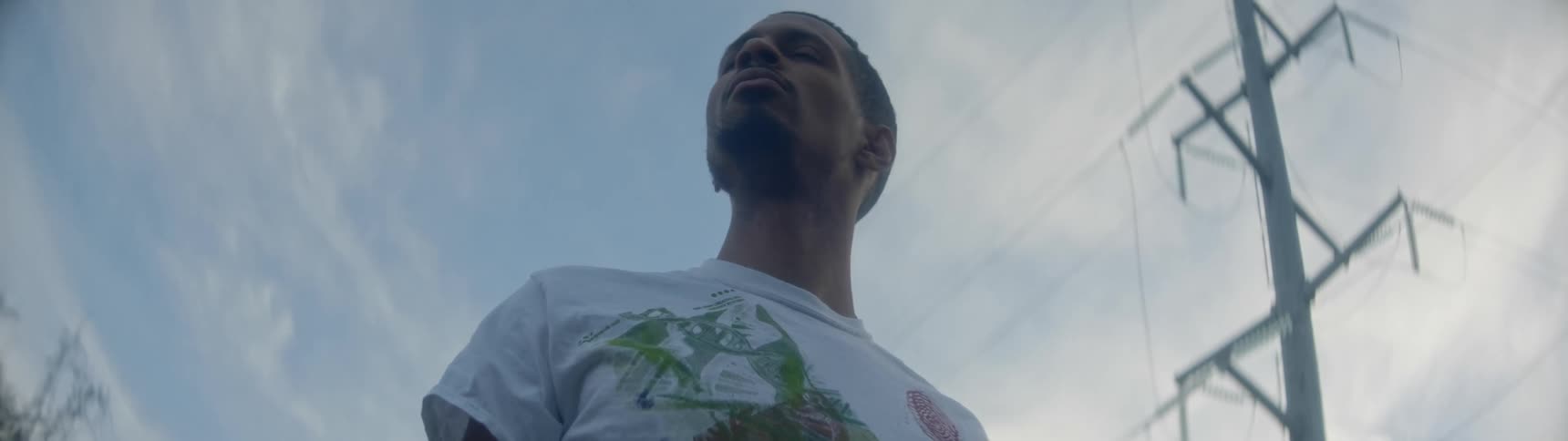 A man stands outside and looks around