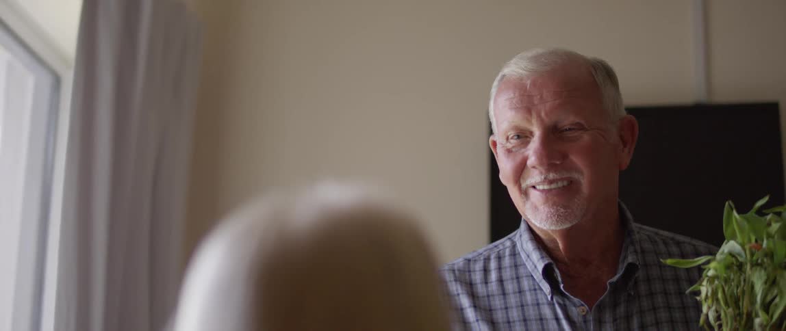 Elderly man speaks to the woman at home