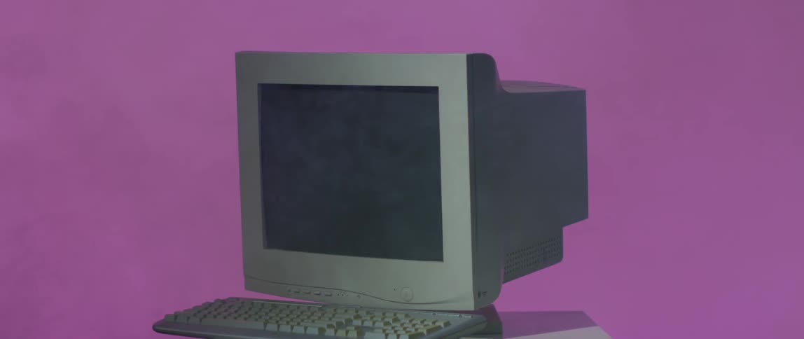 A computer sitting on a desk in an office