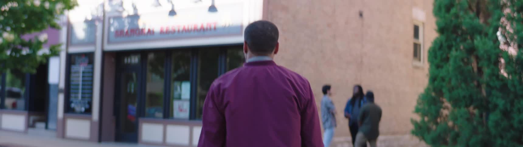 A man crosses the street to see his friends