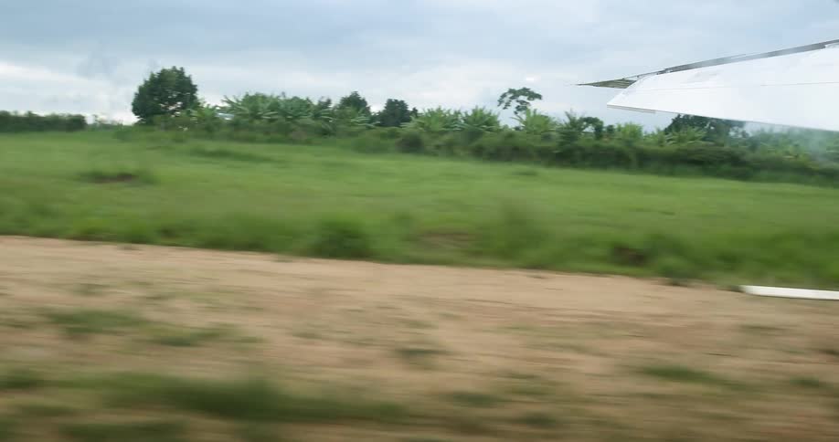 An airplane drives on a dirt runway