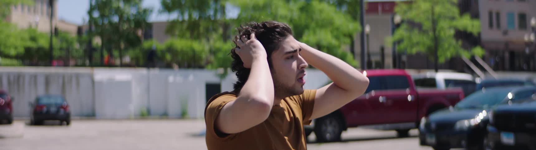 A man yelling at someone in a car driving away
