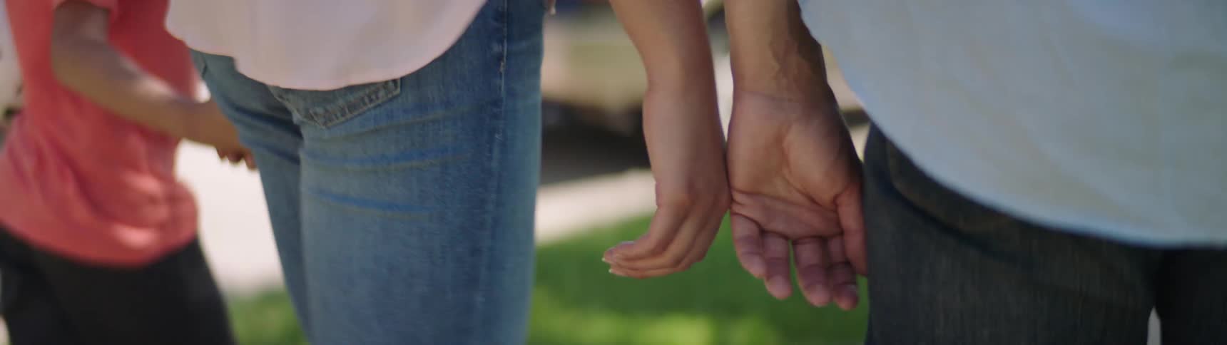 A family walks along and holds hands