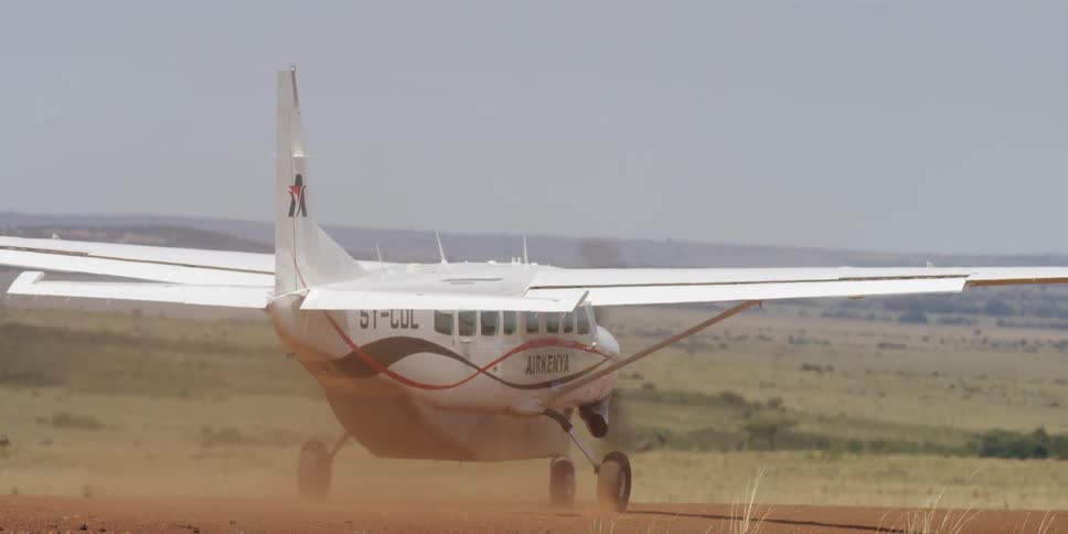 A plane drives down a dirt runway