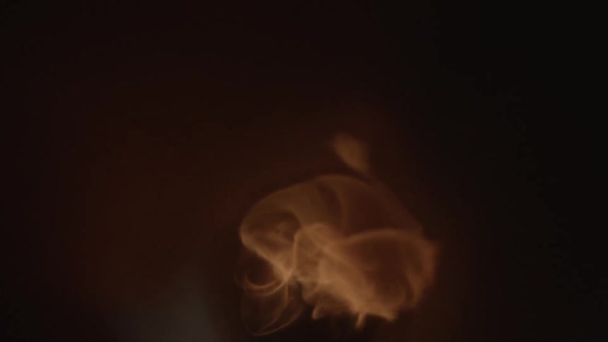A fire coming out of an exhaust pipe and afterwards smoke
