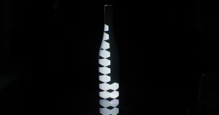 A dark bottle with flashing shapes lighting up on it